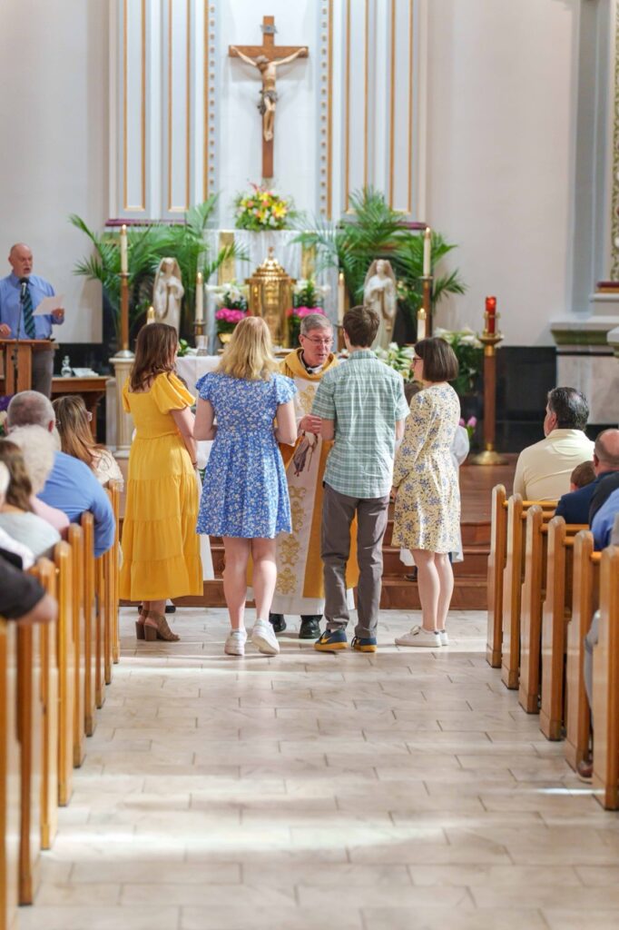 New confirmands bring up the gifts at Holy Trinity Parish in East Liverpool.