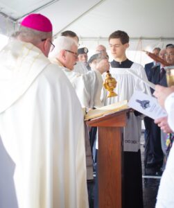 Msgr Cariglio incenses the Bible at blessing of statue. Photo by Courtney Poullas