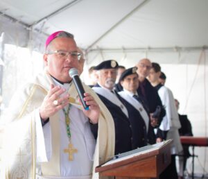 Bishop Bonnar speaks at a podium during statue blessing at basilica in youngstown. Photo by Courtney Poullas