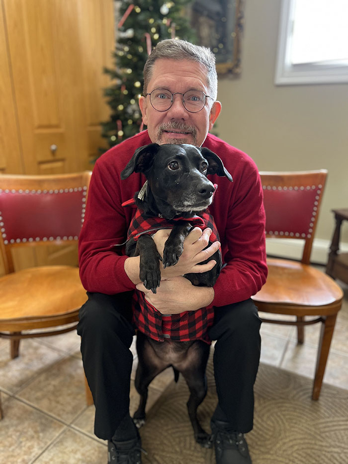 bishop-elect poses with his dog, Arwen