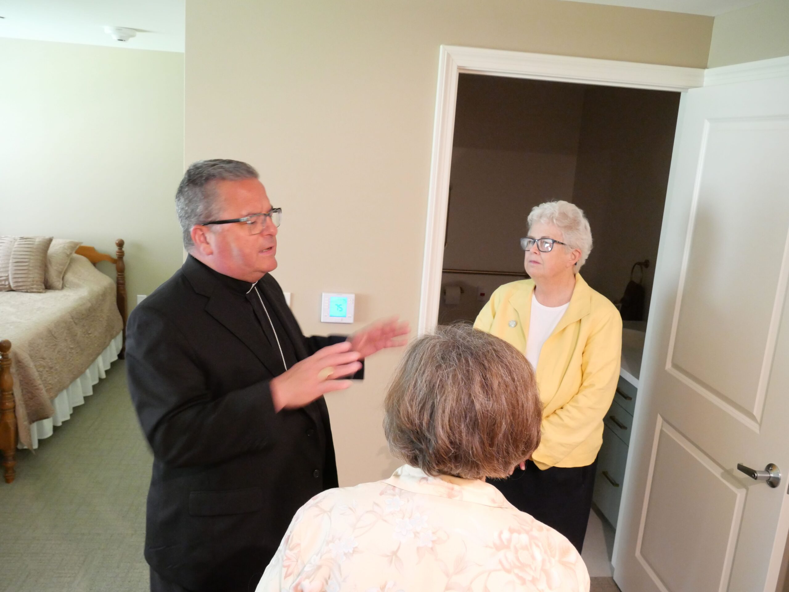 Bishop Bonnar asks the sisters a question about their renovations. Photo by Michael Houy