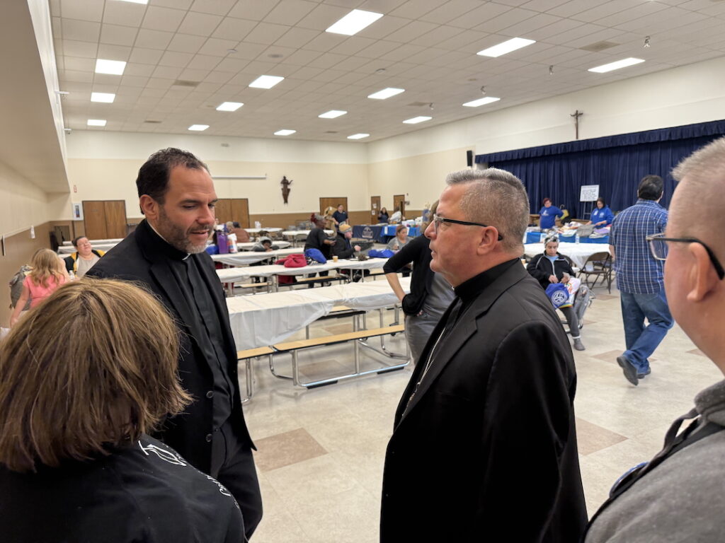 Bishop Bonnar talks to Father Cicero at the community Day of Hope