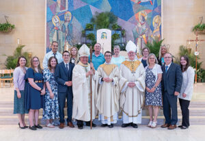 Father Travis Seagraves with Bishop Bonnar and family after his ordination to the priesthood.
