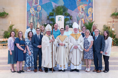 Father Travis Seagraves with Bishop Bonnar and family after his ordination to the priesthood.