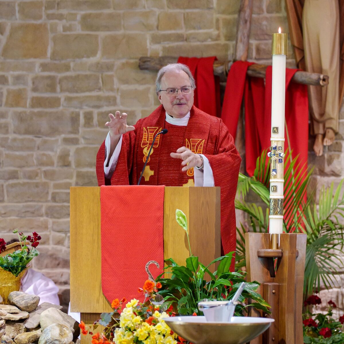 Image of Father Merzweiler at the pulpit during his retirement Mass
