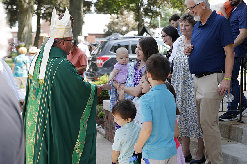 A photo of Bishop Bonnar greeting participants at the Poor Clare's annual picnic in Canton.