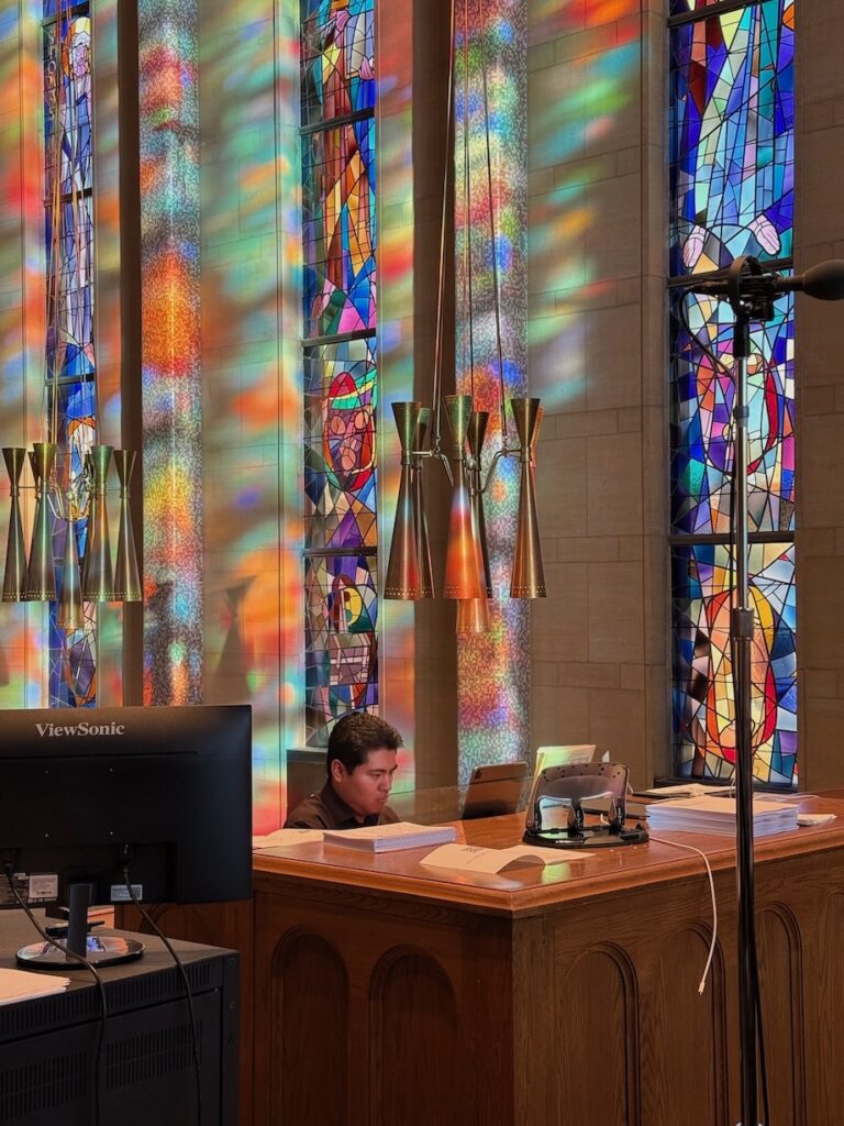 a man plays the organ in the choir loft at the cathedral