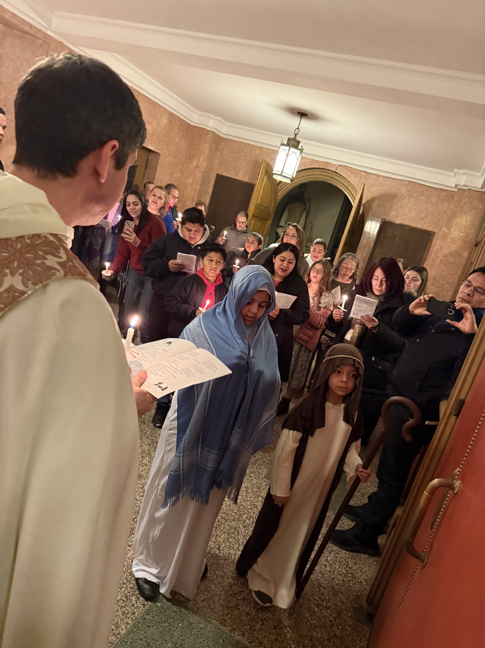 Father Frassati reads to those gathered for Las Posadas