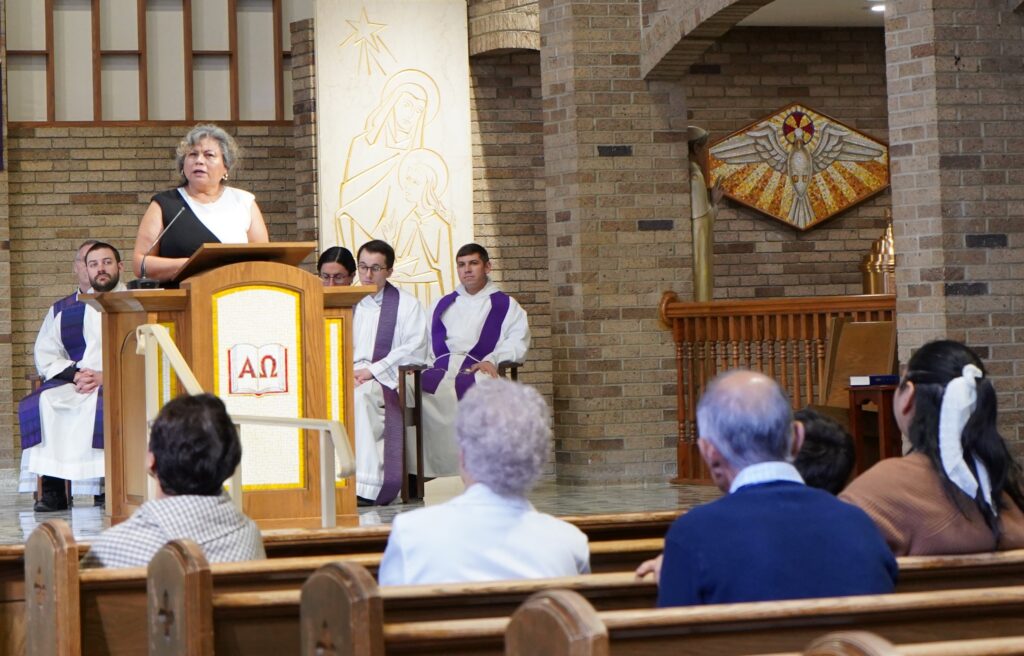 Cristina Hernandez does the reading at the fourth annual hispanic summit. Photo by Paulina Montaldo