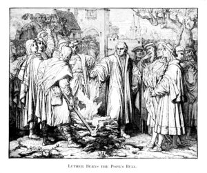 Martin Luther burns the Papal Bull threatening him with excommunication.